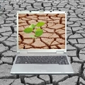 Image of laptop computer on cracked earth